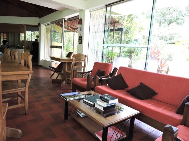 a living room with red couches and tables